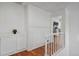 Bright upstairs hallway featuring hardwood floors and white bannister at 10291 Carrara Ter, Parker, CO 80134