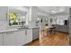 Well-appointed kitchen with modern appliances, white cabinets, granite counters, and eat-in area at 10291 Carrara Ter, Parker, CO 80134