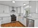 Well-lit kitchen featuring stainless steel appliances, a subway tile backsplash, and solid countertops at 10291 Carrara Ter, Parker, CO 80134