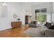 Bright open concept living room with hardwood floors, comfortable seating, and natural light streaming through windows at 10291 Carrara Ter, Parker, CO 80134