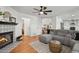 Open-concept living area with fireplace and easy access to the kitchen and stairs to the upper level at 10291 Carrara Ter, Parker, CO 80134