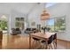 Bright living room featuring hardwood floors, large windows, and neutral furnishings with vaulted ceilings at 10291 Carrara Ter, Parker, CO 80134