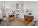 Spacious living room with hardwood floors, a dining area, and staircase leading to the upper level in a well-lit space at 10291 Carrara Ter, Parker, CO 80134