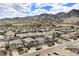 Panoramic aerial view of a residential community with mountain views, and lush landscaping at 15784 Burrowing Owl Ct, Morrison, CO 80465