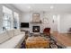 Cozy living room featuring a stone fireplace and natural light from the large window at 15784 Burrowing Owl Ct, Morrison, CO 80465