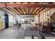 Unfinished basement with exercise equipment, exposed ceiling beams, and open area for activities at 8196 Wetherill Cir, Castle Pines, CO 80108