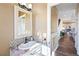 Stylish half bathroom featuring mosaic tile accents, a decorative mirror, and a glimpse into the adjacent kitchen at 8196 Wetherill Cir, Castle Pines, CO 80108