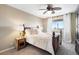 Charming bedroom featuring a comfortable bed, a ceiling fan, and a window with natural light at 8196 Wetherill Cir, Castle Pines, CO 80108