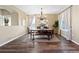 Inviting dining room showcasing hardwood floors, a chandelier, and a charming ambiance at 8196 Wetherill Cir, Castle Pines, CO 80108