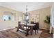 Elegant dining room featuring a wooden table, stylish chandelier, and hardwood floors at 8196 Wetherill Cir, Castle Pines, CO 80108