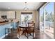 Cozy dining room with a round wooden table, chandelier, and sliding glass doors leading to an outdoor deck at 8196 Wetherill Cir, Castle Pines, CO 80108