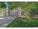 Charming home featuring a three-car garage, well-manicured lawn, and attractive landscaping at 8196 Wetherill Cir, Castle Pines, CO 80108