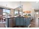 A kitchen with modern appliances, a central island, and open access to the dining and living areas, offering a seamless flow at 8196 Wetherill Cir, Castle Pines, CO 80108