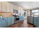 A modern kitchen with painted cabinets, stainless steel appliances, and a large window, combining functionality with style at 8196 Wetherill Cir, Castle Pines, CO 80108