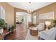 Open-concept living room with hardwood floors, elegant furnishings, and natural light at 8196 Wetherill Cir, Castle Pines, CO 80108