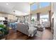 A comfortable living room with high ceilings, large windows, and an open layout, flowing into the kitchen and dining area at 8196 Wetherill Cir, Castle Pines, CO 80108