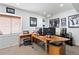 Bright home office with a spacious wooden desk, multiple monitors, and natural light from a window at 8196 Wetherill Cir, Castle Pines, CO 80108