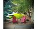 Serene outdoor seating area with Adirondack chairs, mature landscaping, and tranquil setting at 8196 Wetherill Cir, Castle Pines, CO 80108