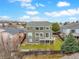 Expansive two-story home with large windows, gray siding, green lawn, and a wooden back deck at 8196 Wetherill Cir, Castle Pines, CO 80108