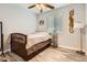 Comfortable bedroom features a ceiling fan, a wooden bed frame with storage drawers, and modern flooring at 8317 Liverpool Cir, Littleton, CO 80125
