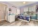 A bedroom with a desk and chair beside a bed with blue comforter with hardwood style floor at 8317 Liverpool Cir, Littleton, CO 80125