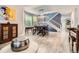 Open dining room features a dining table, modern light fixture, and staircase at 8317 Liverpool Cir, Littleton, CO 80125