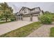 Well-maintained two-story home with a three-car garage, landscaping, and a welcoming front porch at 8317 Liverpool Cir, Littleton, CO 80125