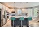 Modern kitchen featuring stainless steel appliances, a large island with seating, and pendant lighting at 8317 Liverpool Cir, Littleton, CO 80125