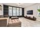 Relaxing living room with a comfortable couch, ottomans, entertainment center and view to the adjacent office space at 8317 Liverpool Cir, Littleton, CO 80125