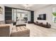 Relaxing living room with a comfortable couch, ottomans, entertainment center and view to the adjacent office space at 8317 Liverpool Cir, Littleton, CO 80125