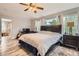 Bright main bedroom with a desk, and an ensuite bathroom, with two large windows allowing natural light at 8317 Liverpool Cir, Littleton, CO 80125