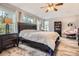 Spacious main bedroom with large windows, a comfortable bed, and stylish furnishings with hardwood style floor at 8317 Liverpool Cir, Littleton, CO 80125
