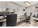 Well-lit office space featuring modern desks, multiple monitors, and a comfortable ergonomic chair at 8317 Liverpool Cir, Littleton, CO 80125