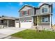Charming two-story home with a three car garage and a welcoming front porch on a sunny day at 3514 Belleville Ridge Rd, Elizabeth, CO 80107