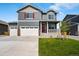 Charming two-story home with a three car garage and a welcoming front porch and well manicured lawn at 3514 Belleville Ridge Rd, Elizabeth, CO 80107