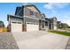 Charming two-story home with a three car garage and a welcoming front porch and well manicured lawn at 3514 Belleville Ridge Rd, Elizabeth, CO 80107