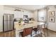 Kitchen features a stainless steel refrigerator, granite countertops, and a breakfast bar at 3514 Belleville Ridge Rd, Elizabeth, CO 80107