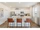 Kitchen boasts white cabinetry, stainless appliances, granite counters, and a large island at 3514 Belleville Ridge Rd, Elizabeth, CO 80107
