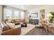 Bright living room with leather sofas, a modern rug, and large windows at 3514 Belleville Ridge Rd, Elizabeth, CO 80107