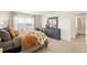 Serene bedroom with a large window, plush bedding, and a rustic dresser with a mirror at 3514 Belleville Ridge Rd, Elizabeth, CO 80107