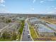 Expansive aerial view of a well-maintained neighborhood with tree-lined streets under a bright, partly cloudy sky at 5800 Tower Rd # 610, Denver, CO 80249