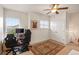 Bright bedroom provides a functional space with ceiling fan, closet and natural light from the windows at 5800 Tower Rd # 610, Denver, CO 80249