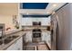 Modern kitchen featuring stainless steel appliances, white cabinets, and an open layout at 5800 Tower Rd # 610, Denver, CO 80249