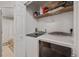 Functional laundry room space with a washer and dryer and additional storage shelf at 5800 Tower Rd # 610, Denver, CO 80249