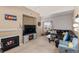 Inviting living room with a cozy fireplace, comfortable seating, and plenty of natural light at 5800 Tower Rd # 610, Denver, CO 80249