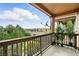 Balcony with wooden railing and view of street and treeline at 8489 Canyon Rim Cir # 302, Englewood, CO 80112