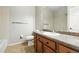 Standard bathroom with neutral color palette, wood vanity, and tiled shower-tub combo at 8489 Canyon Rim Cir # 302, Englewood, CO 80112