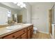 Bathroom with dual sinks, tiled countertop, and a glass-enclosed shower offering a modern and functional design at 8489 Canyon Rim Cir # 302, Englewood, CO 80112
