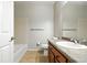 Bathroom with standard fixtures, including tile flooring, wood vanity, and shower over tub at 8489 Canyon Rim Cir # 302, Englewood, CO 80112