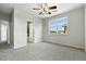 Well-lit bedroom features a ceiling fan, large window, and en suite bathroom for added convenience and privacy at 8489 Canyon Rim Cir # 302, Englewood, CO 80112